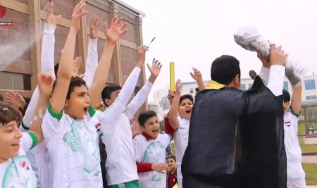 International Academy students celebrate the Iraqi national team winning a cup (Gulf 25) in their own way